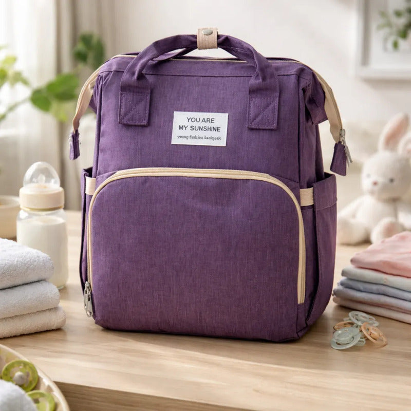 Pañalera Tipo Morral  Con Bolsillos Termicos Y Cambiador Morado Lisa